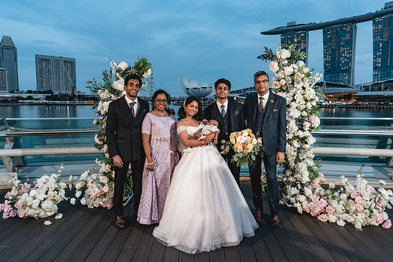Shirouz and his family in formal wedding attire at Marina Bay, Singapore